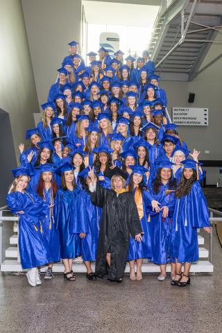 Dual Enrollment students Kate Smith with dual enrollment graduates on the grand staircase at the Arizona Federal Theatre