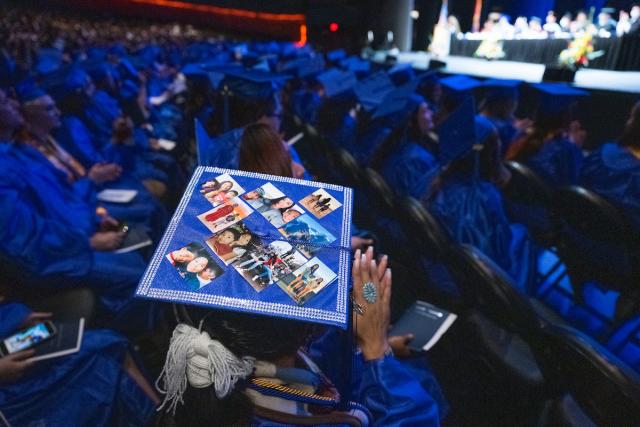 A graduation cap embellished with family photos