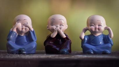 Three monk figures doing "say no/see no/hear no evil"