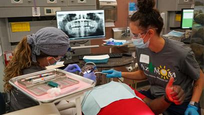 image of dental students working on a patient.