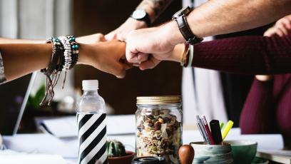 People at a meeting doing fist bumps