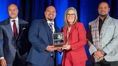 photo of Cordero Holmes with Governor Katie Hobbs holding the MLK Living the Dream award.