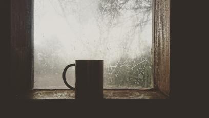 Coffee cup in front of a frosted window