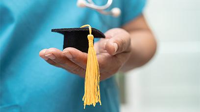 image of nursing student holding a miniature felt grad cap 