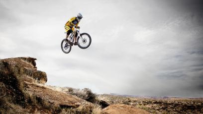 Mountain bike jumping over a desert