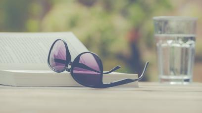 Sunglasses set on top of a book outside