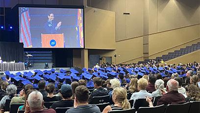 Attendees and HSE graduates listen to a speaker at the podium during the graduation ceremony