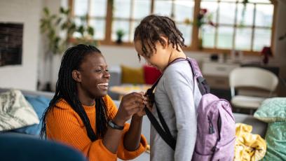 Parent helping her child get ready for school