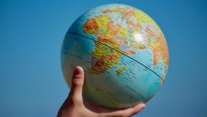 Hand holding up a globe