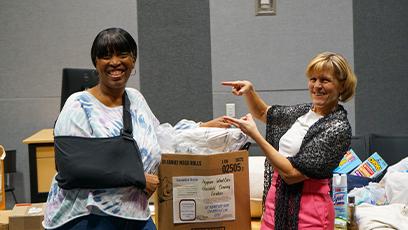 President Smith with Tara Hayman at the packing event