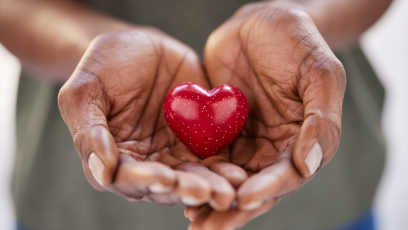 A pair of hands holding a sparkling heart