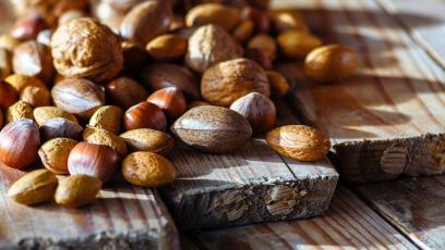 A table strewn with walnuts, chestnuts, and other nuts