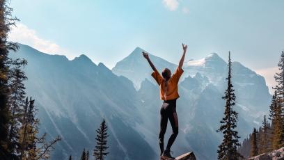 Woman exercising in front of a mountain