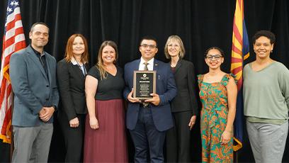 Rio southern staff pose with the plague commemorating 10 years