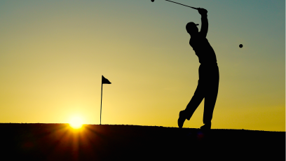 Silhouette of a man playing golf