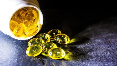 Omega-3 supplements spilling out of pill bottle