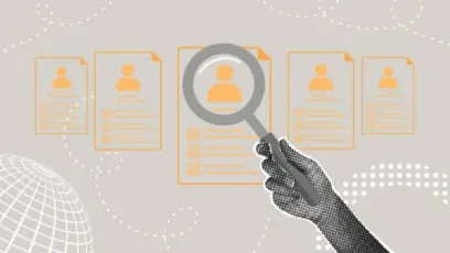A hand holding a magnifying glass over a lineup of resumes