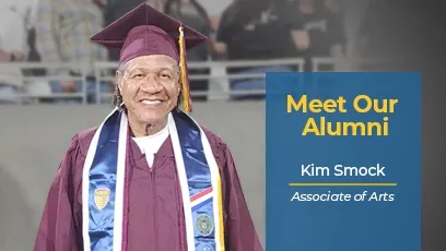 Kim Smock, a Rio Salado College graduate, smiles while wearing a maroon cap and gown with a white stole and several graduation medallions. Text beside the photo reads: “Meet Our Alumni – Kim Smock, Associate of Arts.” The image celebrates his academic achievement and Rio Salado College pride.