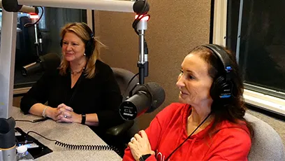 Robin Arredondo-Savage, president and CEO of the Tempe Chamber of Commerce, and Lisa Hausz, program manager in the City of Tempe’s economic development division, sit in a recording studio wearing headphones and speaking into microphones during Rio Salado College’s Wave Makers podcast.