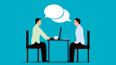 Two people having a conversation over a table