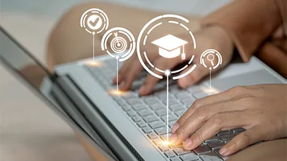 Hands typing on a laptop keyboard with digital education icons, including a graduation cap, target, checkmark, and magnifying glass, displayed above the screen.