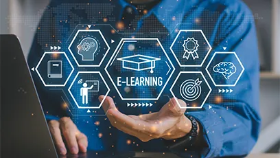 Person using a laptop with digital e-learning icons, including a graduation cap, certificate, instructor, brain, and target, displayed above an outstretched hand with the text “E-Learning.”