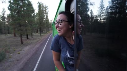 photo of Mariah Schneider looking out the window of a RV