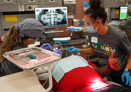 image of dental students working on a patient.