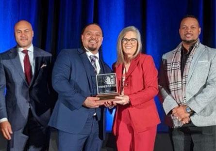 photo of Cordero Holmes with Governor Katie Hobbs holding the MLK Living the Dream award.