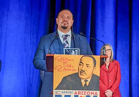 Cordero Holmes at the podium during MLK Celebration breakfast