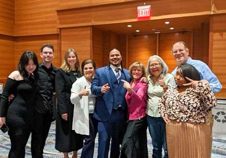 Cordero Holmes, Rio President Kate Smith and staff of Student Life department posing for a group photo.