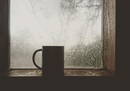 Coffee cup in front of a frosted window