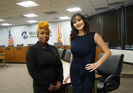 Brianna Bonnell and Beka Namachanja posing together in the MCCCD Governing Board Room