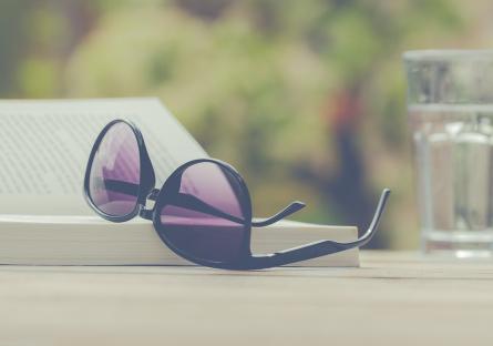 Sunglasses set on top of a book outside