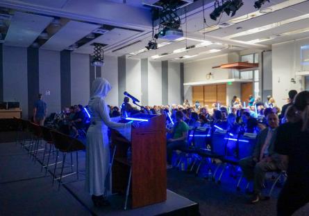 President Smith stands at the podium, welcoming attendees to the planning day event