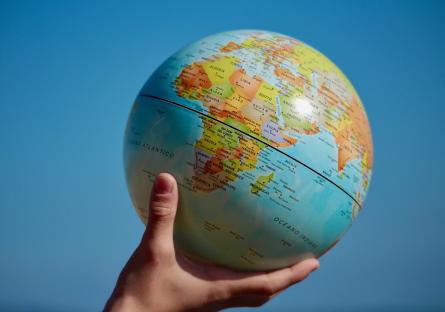 Hand holding up a globe