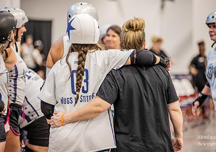 photo of Laura coaching her daughter at a roller derby event