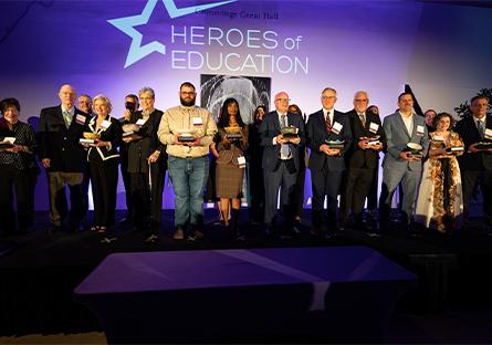 Pat Case and other honorees on stage posing with their awards.