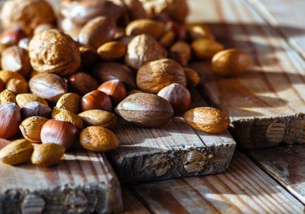 A table strewn with walnuts, chestnuts, and other nuts