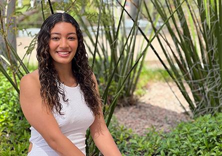 Alivia Proctor portrait sitting down in a xeriscape garden at Rio Tempe