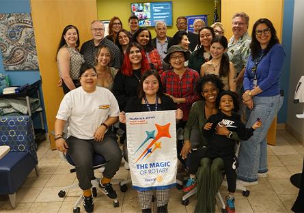 group gathers to pose with the Rotaract Club banner