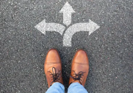 A pair of shoes stand at a crossroads