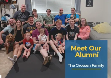 A large family group photo taken indoors, showing multiple adults, children, and a dog sitting together and smiling at the camera. On the right side, a blue text box reads: Meet Our Alumni – The Grossen Family.