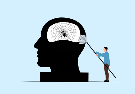 Man sweeping cobwebs and a spider out of the inside of a large silhouette of a head