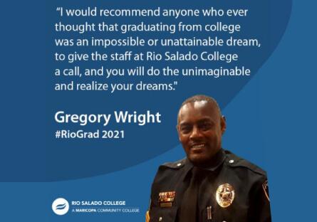 Gregory Wright in uniform smiling at camera in front of blue waves background.