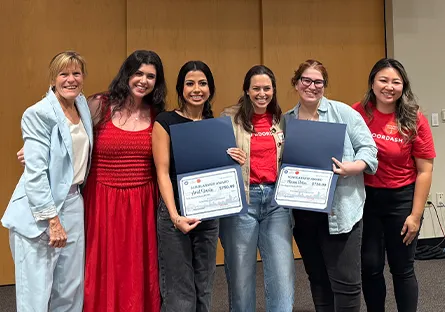 Rio Salado College President Kate Smith and DoorDash representatives stand with scholarship recipients Ariel Davila and Maren “Rain” Colon, who hold scholarship certificates at the Tempe Local Business Workshop.
