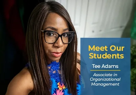 A close-up selfie portrait of Tee Adams, a Black woman with long straight brown hair and black framed glasses, wearing a blue floral top. A dark blue graphic overlay in the bottom-right corner features white and yellow text stating: "Meet Our Students | Tee Adams | Associate in Organizational Management".
