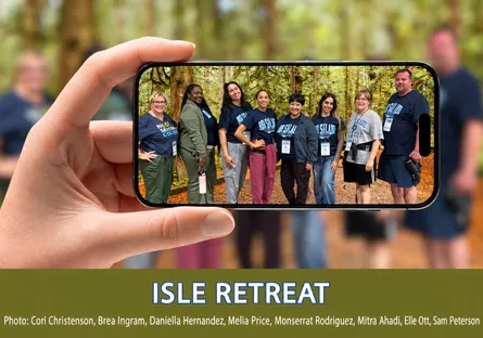 An image featuring a close-up of a hand holding up a smartphone against a blurred forest background. On the phone screen, eight Rio Salado College participants stand together outdoors surrounded by trees. Below the phone graphic, bold white text with blue outlining on a dark green banner reads "ISLE RETREAT", followed by photo credit text listing Cori Christenson, Brea Ingram, Daniella Hernandez, Melia Price, Monserrat Rodriguez, Mitra Ahadi, Elle Ott, and Sam Peterson.