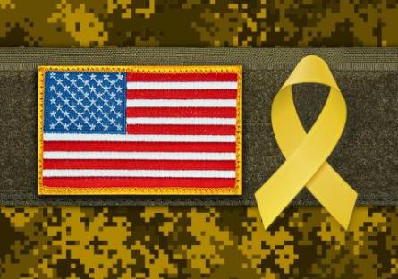 photo of the U.S. Flag and a yellow ribbon, camouflage background design