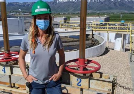 Female JBS employee engineer wearing hard hat and face mask